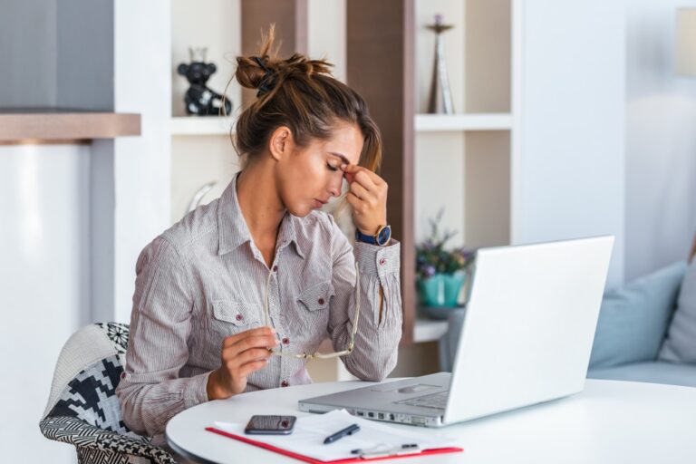Young,Frustrated,Woman,Working,At,Office,Desk,In,Front,Of