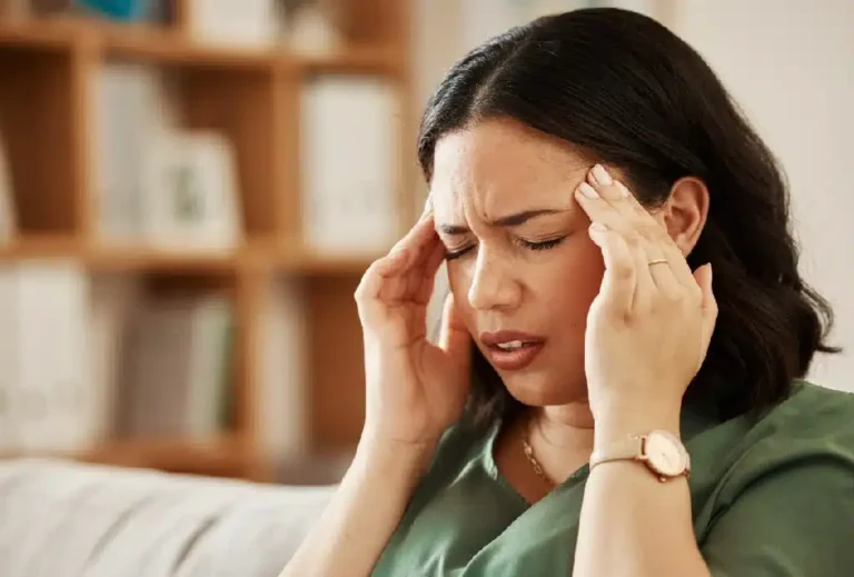 Stress headache and woman on a sofa with vertigo
