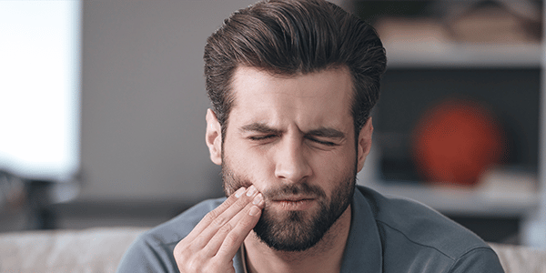 man with tooth pain from tmj